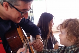 "Mr. Gabe" Hutter ’88 plays guitar for a young fan